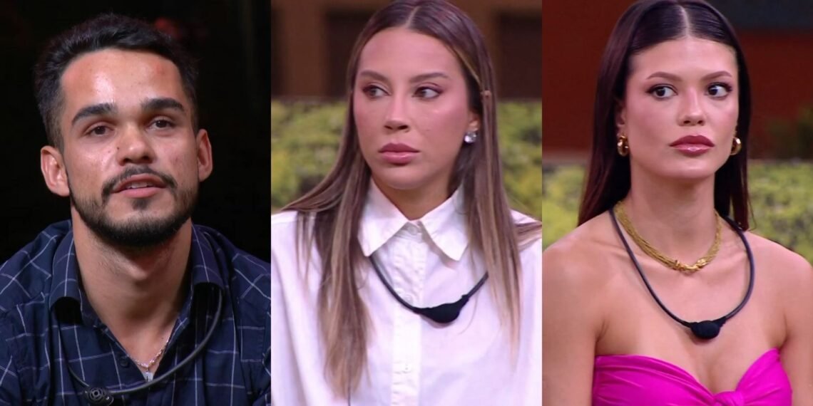 Três pessoas em um reality show, exibindo expressões sérias e tensas, usando microfones de lapela em um cenário interno.