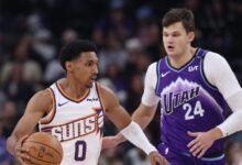 Oct 27, 2025; Salt Lake City, Utah, USA; Phoenix Suns forward Ryan Dunn (0) brings the ball up the court against Utah Jazz center Walker Kessler (24) during the first quarter at Delta Center. Mandatory Credit: Rob Gray-Imagn Images