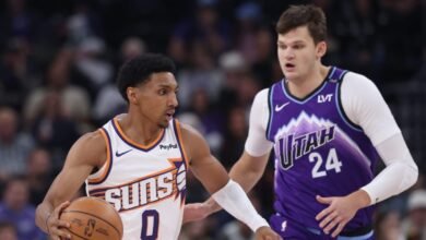 Oct 27, 2025; Salt Lake City, Utah, USA; Phoenix Suns forward Ryan Dunn (0) brings the ball up the court against Utah Jazz center Walker Kessler (24) during the first quarter at Delta Center. Mandatory Credit: Rob Gray-Imagn Images