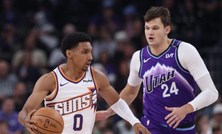 Oct 27, 2025; Salt Lake City, Utah, USA; Phoenix Suns forward Ryan Dunn (0) brings the ball up the court against Utah Jazz center Walker Kessler (24) during the first quarter at Delta Center. Mandatory Credit: Rob Gray-Imagn Images