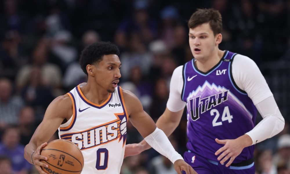 Oct 27, 2025; Salt Lake City, Utah, USA; Phoenix Suns forward Ryan Dunn (0) brings the ball up the court against Utah Jazz center Walker Kessler (24) during the first quarter at Delta Center. Mandatory Credit: Rob Gray-Imagn Images