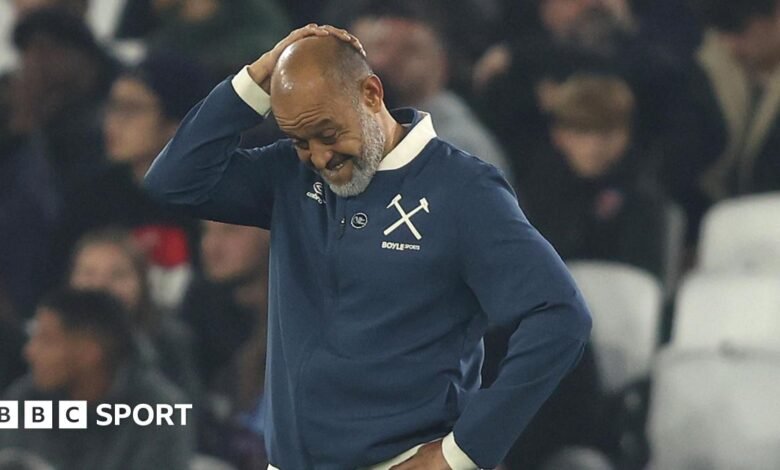 Nuno Espirito Santo looks downwards with his right hand clasped to the top of his head during West Ham