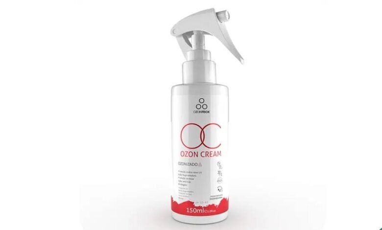 Frasco branco de 150 ml do creme Ozon Cream com aplicador spray na cor branca. Rótulo apresenta texto em vermelho e preto, incluindo o nome do produto e volume.